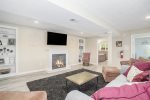Lower level living area with electric fireplace and smart TV